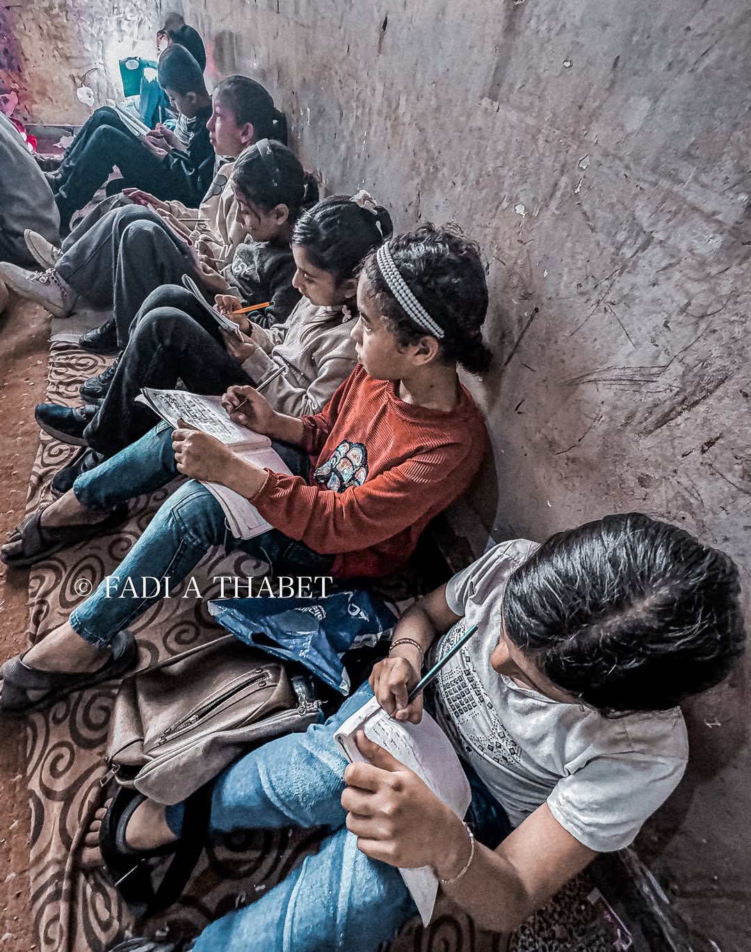 Gaza: Children write on knees, continue education despite all