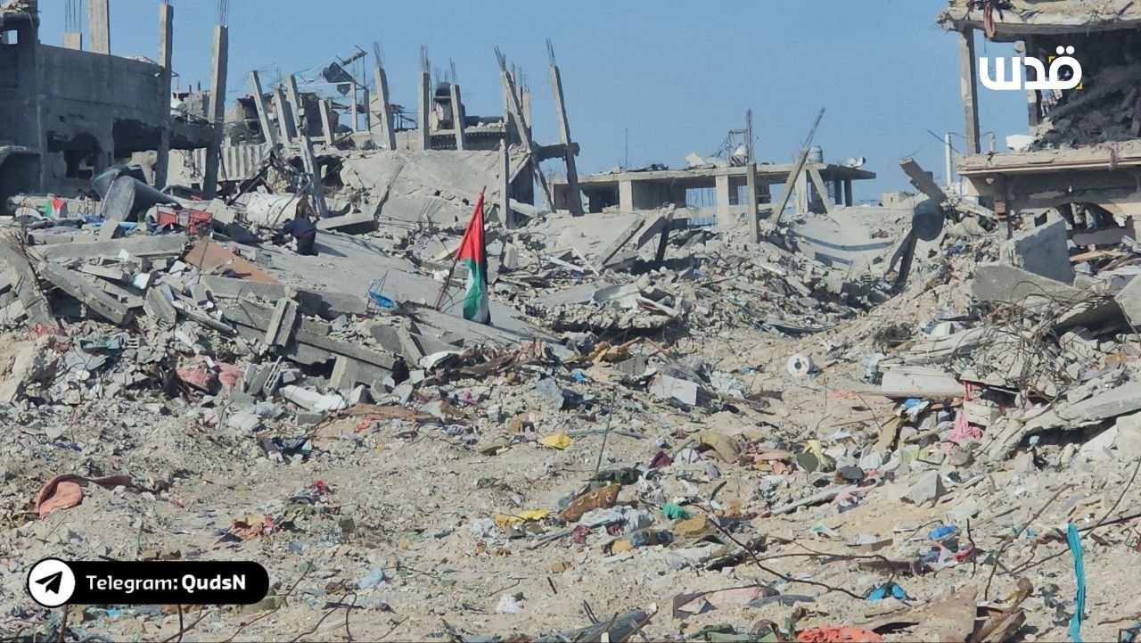 Palestinian flag amid rubble of destroyed Jabalia camp homes