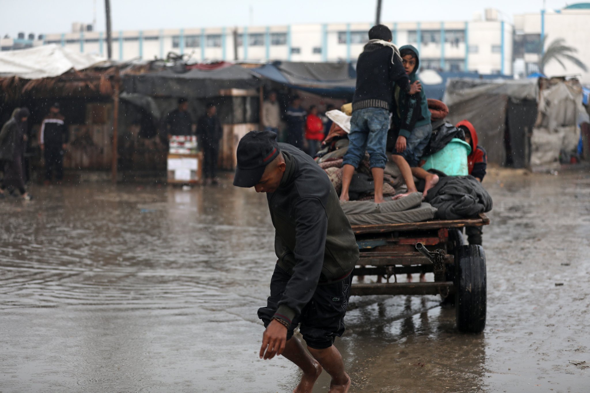 15-year-old Mahmoud Saleh pulls water cart to Gaza displacement camps