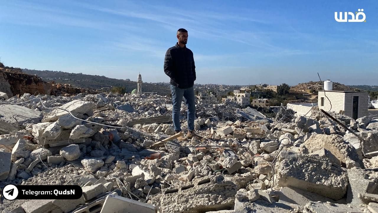 Palestinian inspects rubble of demolished home in Al-Walaja