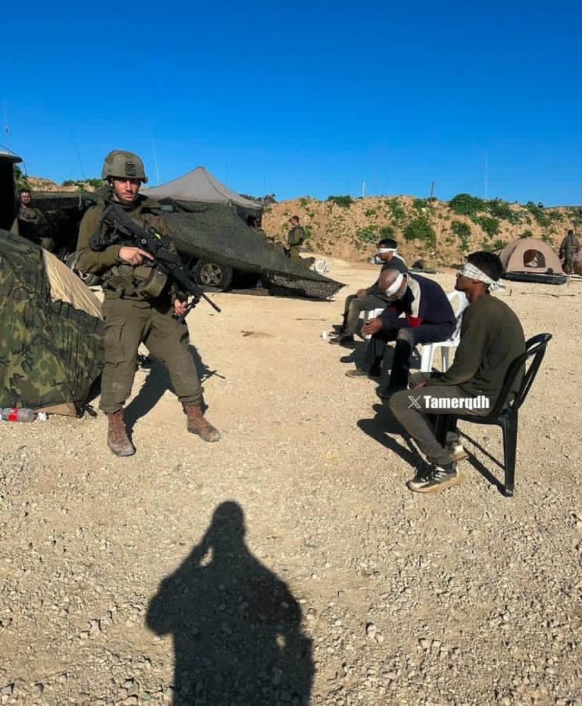 Israeli soldier shows three blindfolded Palestinians abducted from Jabalia
