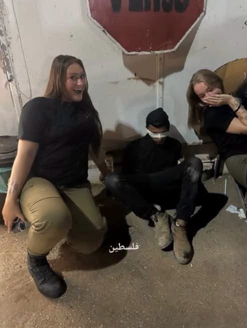 Image shows Israeli soldiers over restrained Palestinian detainee