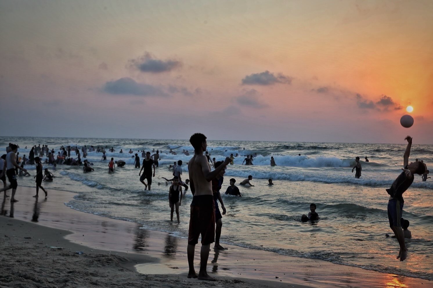 Palestinians in Gaza seek sea relief amid siege and heatwaves