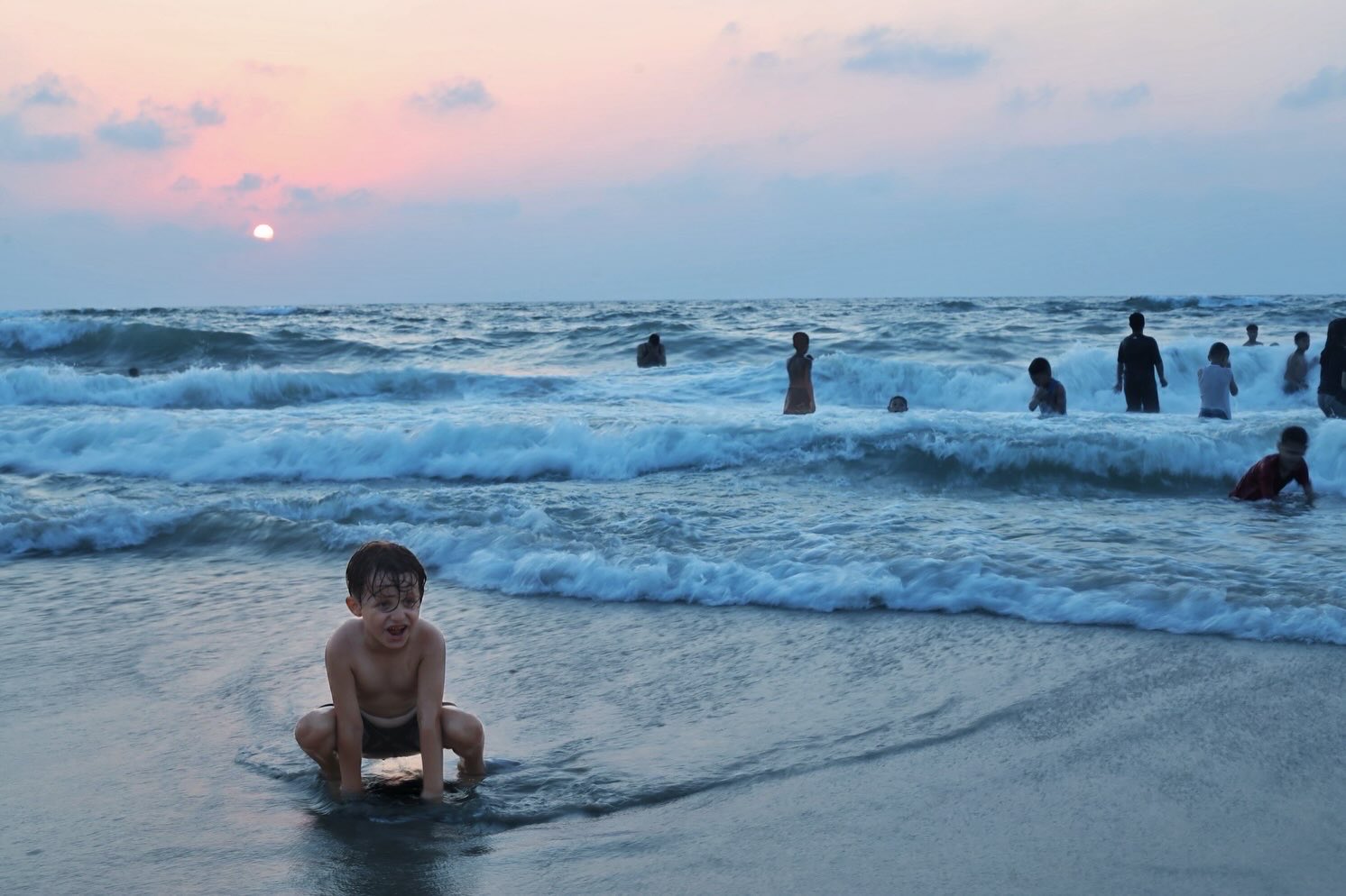 Palestinians in Gaza seek relief from heat at beach amid siege