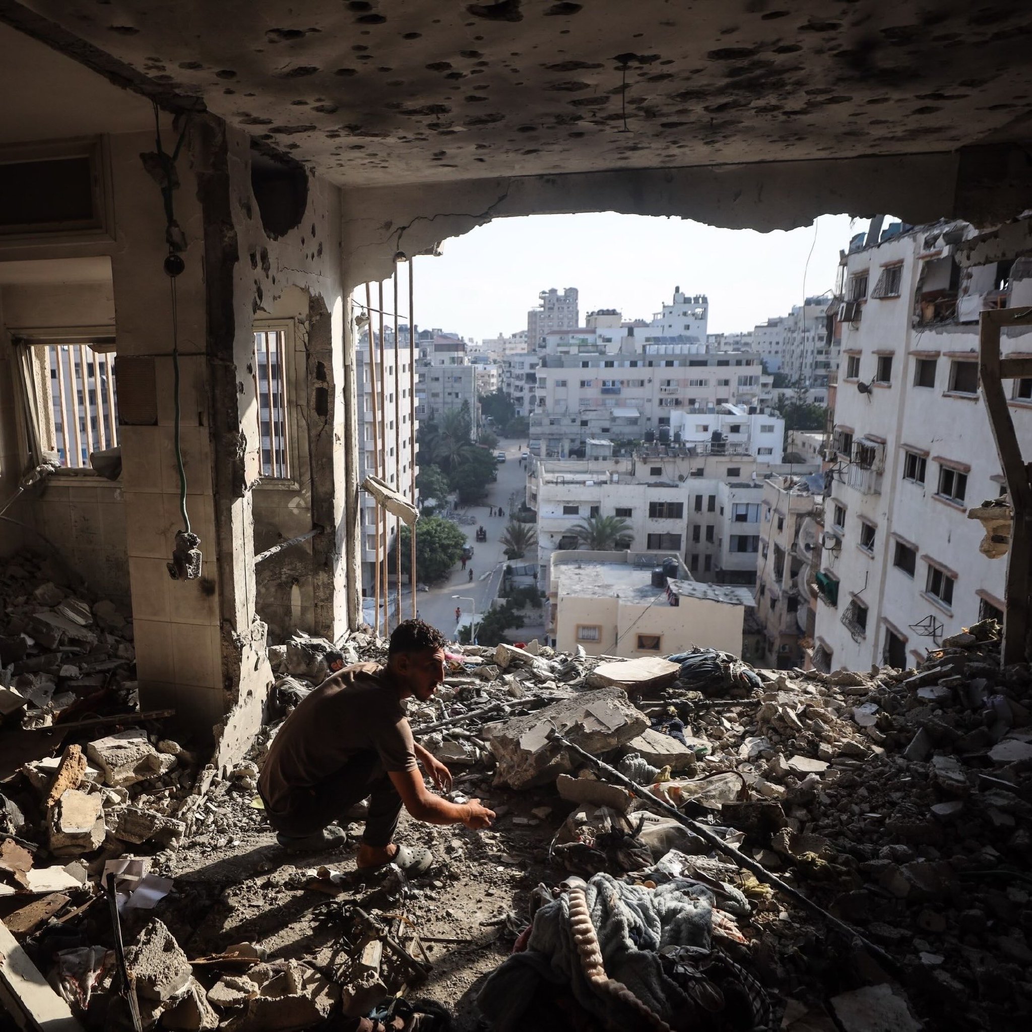 Palestinians inspect destruction of targeted apartment in Gaza City