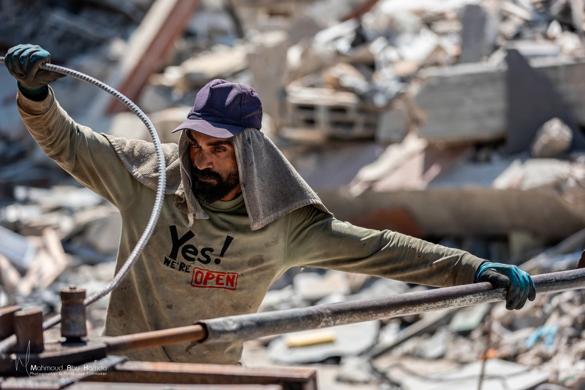 Gazans salvage steel rebar from rubble to build tents for displaced families
